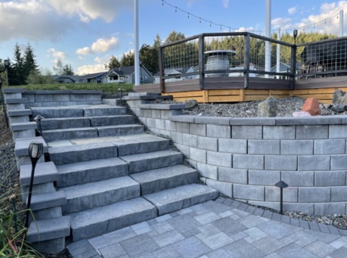 Gray block retaining wall and wide paver steps